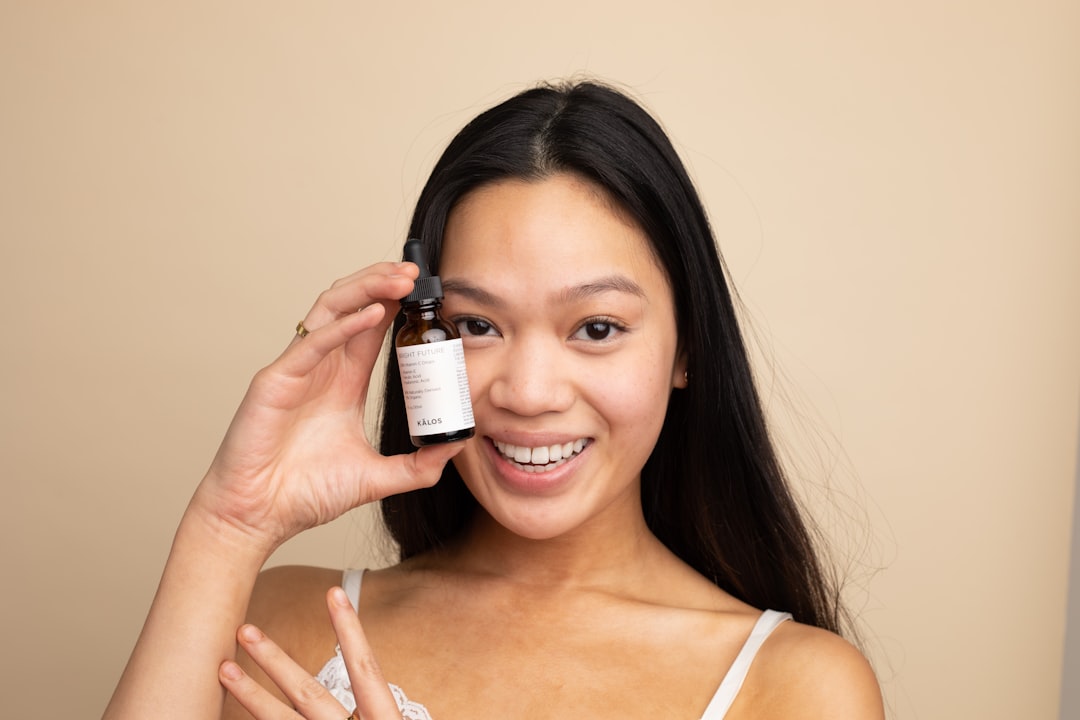 Woman holding a skincare serum bottle for a pigmentation and dark spot routine