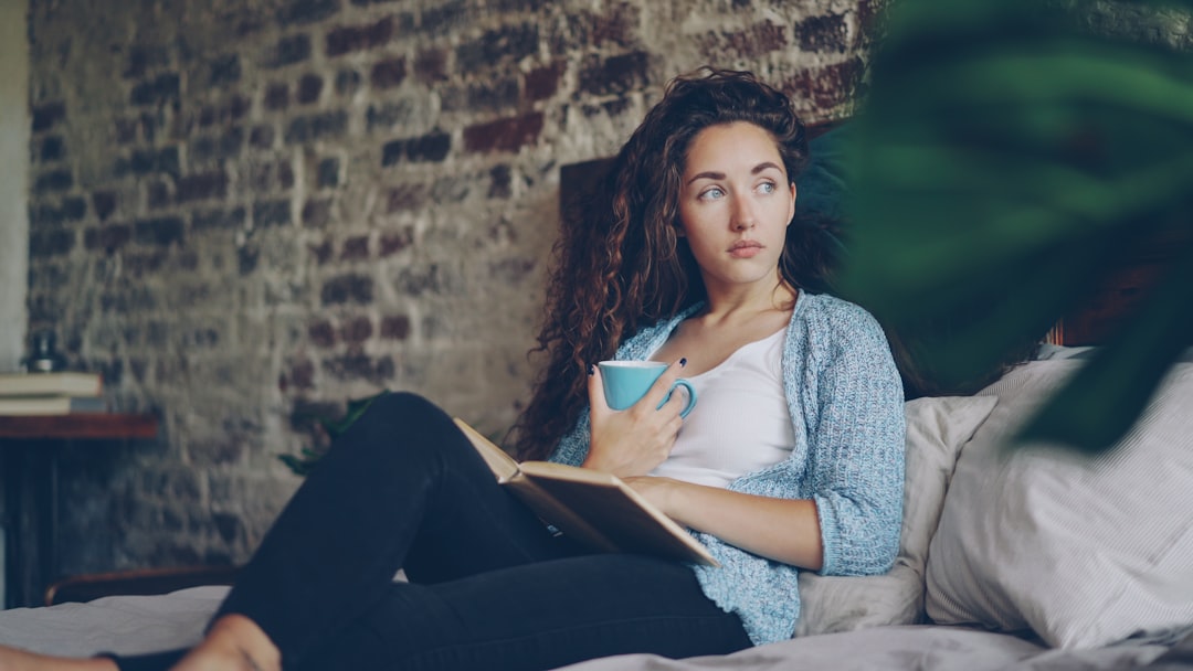 Woman relaxing with a book as part of a balanced wellness routine