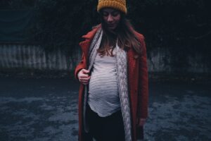 Pregnant woman wearing a stylish Halloween-inspired outfit for costume inspiration